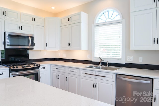 7768 Pinecone Ln, Hickory, NC 28602 - kitchen featuring appliances with stainless steel finishes, a sink, and white cabinets