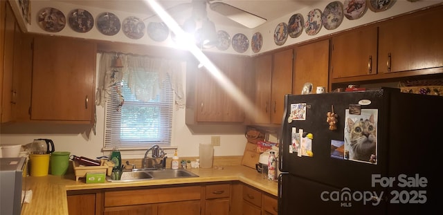 31 Samuel Ln, Candler, NC 28715 - kitchen featuring freestanding refrigerator, a sink, light countertops, and brown cabinetry