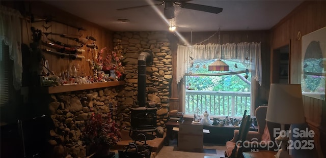 31 Samuel Ln, Candler, NC 28715 - home office featuring a ceiling fan, a wood stove, and wood walls