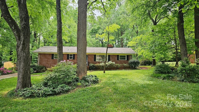 7021 Linda Lake Dr, Charlotte, NC 28215 - ranch-style home featuring a chimney, a front lawn, and brick siding