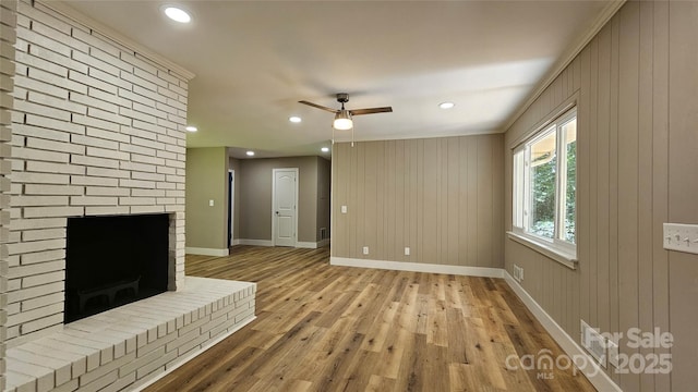 7021 Linda Lake Dr, Charlotte, NC 28215 - unfurnished living room with a fireplace, light wood-type flooring, baseboards, a ceiling fan, and recessed lighting