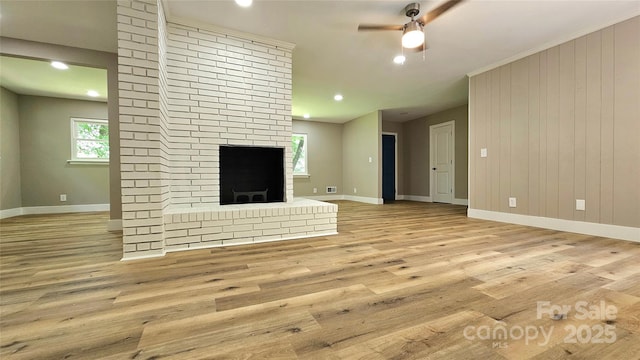 7021 Linda Lake Dr, Charlotte, NC 28215 - unfurnished living room featuring baseboards, a brick fireplace, ceiling fan, wood finished floors, and recessed lighting