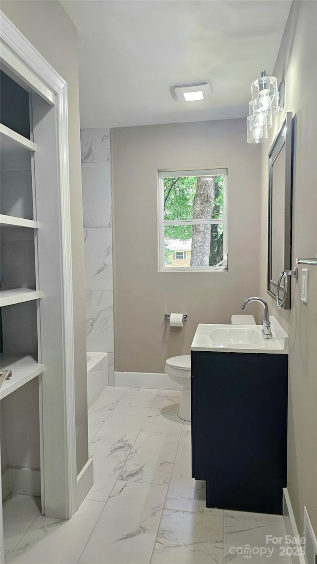 7021 Linda Lake Dr, Charlotte, NC 28215 - full bathroom featuring marble look tile flooring, vanity, toilet, and baseboards