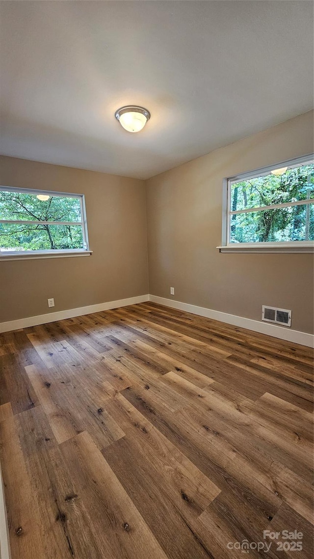 7021 Linda Lake Dr, Charlotte, NC 28215 - spare room featuring healthy amount of natural light, wood finished floors, and baseboards