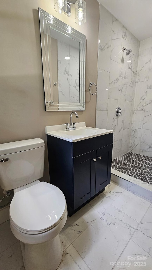 7021 Linda Lake Dr, Charlotte, NC 28215 - bathroom featuring marble look tile flooring, toilet, a stall shower, and vanity