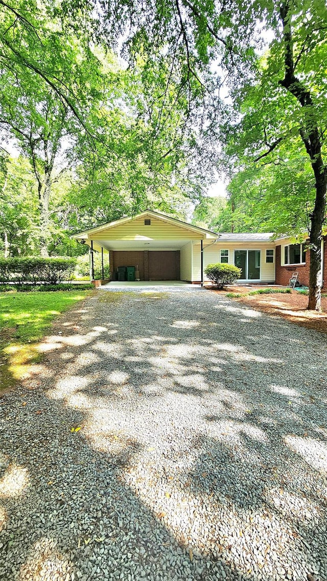 7021 Linda Lake Dr, Charlotte, NC 28215 - view of front of home with driveway, brick siding, and a carport