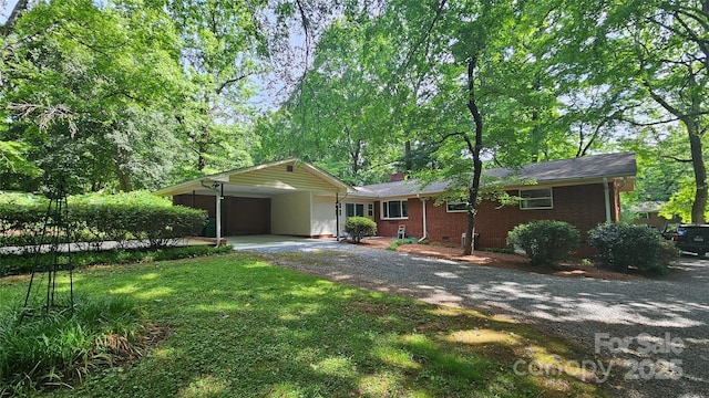 7021 Linda Lake Dr, Charlotte, NC 28215 - single story home with gravel driveway, brick siding, and a chimney