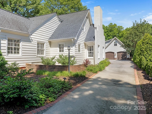 2410 Vernon Dr, Charlotte, NC 28211 - view of front of home with a shingled roof, a chimney, an outdoor structure, and a garage
