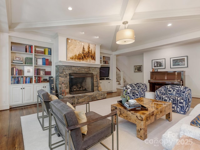 2410 Vernon Dr, Charlotte, NC 28211 - living area featuring wood finished floors, a stone fireplace, crown molding, stairs, and beam ceiling