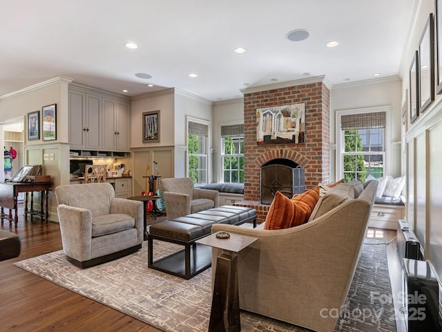 2410 Vernon Dr, Charlotte, NC 28211 - living room with plenty of natural light, dark wood finished floors, ornamental molding, a brick fireplace, and recessed lighting