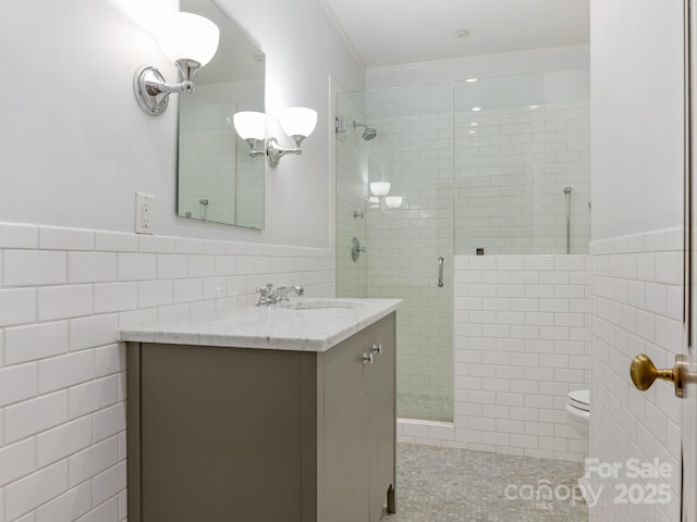 2410 Vernon Dr, Charlotte, NC 28211 - bathroom with tile walls, a shower stall, vanity, and a wainscoted wall
