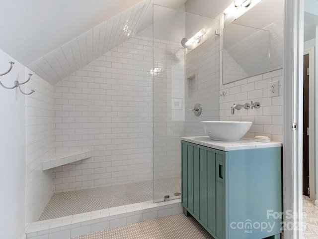 2410 Vernon Dr, Charlotte, NC 28211 - full bathroom featuring lofted ceiling, tiled shower, vanity, tile walls, and tile patterned floors