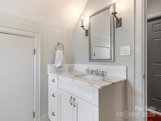 2410 Vernon Dr, Charlotte, NC 28211 - bathroom with vanity and vaulted ceiling