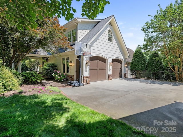 2410 Vernon Dr, Charlotte, NC 28211 - view of property exterior featuring concrete driveway, a shingled roof, brick siding, and a garage