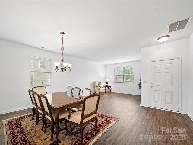 2306 Nettleton Ct, Matthews, NC 28105 - dining room with dark wood-style floors, a chandelier, and baseboards