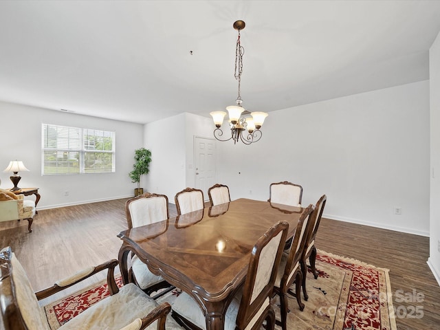 2306 Nettleton Ct, Matthews, NC 28105 - dining area featuring a chandelier, wood finished floors, and baseboards
