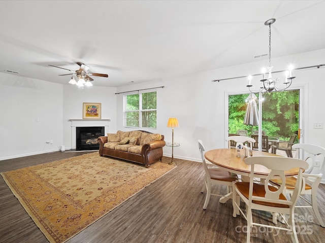 2306 Nettleton Ct, Matthews, NC 28105 - living area with a chandelier, a ceiling fan, dark wood-style flooring, baseboards, and a glass covered fireplace