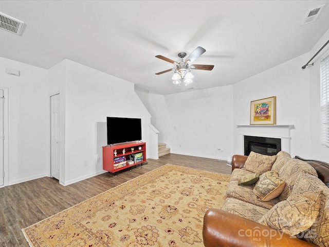 2306 Nettleton Ct, Matthews, NC 28105 - living area featuring wood finished floors, stairway, a ceiling fan, baseboards, and a glass covered fireplace