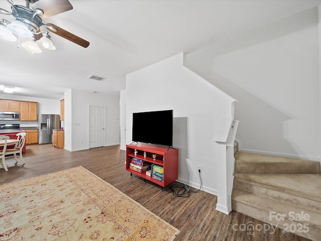 2306 Nettleton Ct, Matthews, NC 28105 - living area featuring wood finished floors, a ceiling fan, baseboards, and stairs