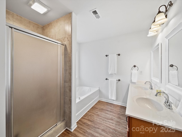 2306 Nettleton Ct, Matthews, NC 28105 - full bath with a stall shower, wood finished floors, a bath, double vanity, and baseboards