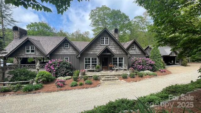973 Sitting Rock Trl, Cullowhee, NC 28723 - view of front of home with board and batten siding, a chimney, and a porch