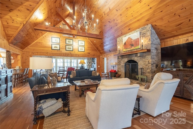973 Sitting Rock Trl, Cullowhee, NC 28723 - living area featuring wood walls, a chandelier, wood finished floors, wood ceiling with exposed beams, and high vaulted ceiling