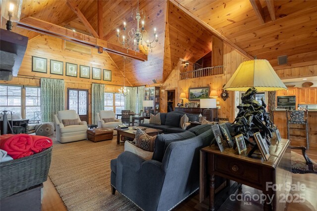 973 Sitting Rock Trl, Cullowhee, NC 28723 - living room featuring a chandelier, wood walls, wood ceiling with exposed beams, and high vaulted ceiling