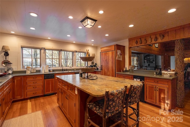 973 Sitting Rock Trl, Cullowhee, NC 28723 - kitchen featuring a sink, light wood-type flooring, a breakfast bar area, brown cabinetry, and recessed lighting
