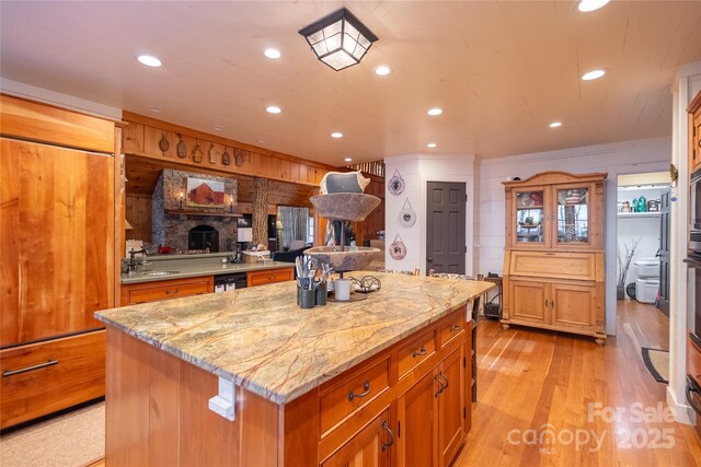 973 Sitting Rock Trl, Cullowhee, NC 28723 - kitchen with light wood-style floors, a sink, a center island, light stone counters, and recessed lighting