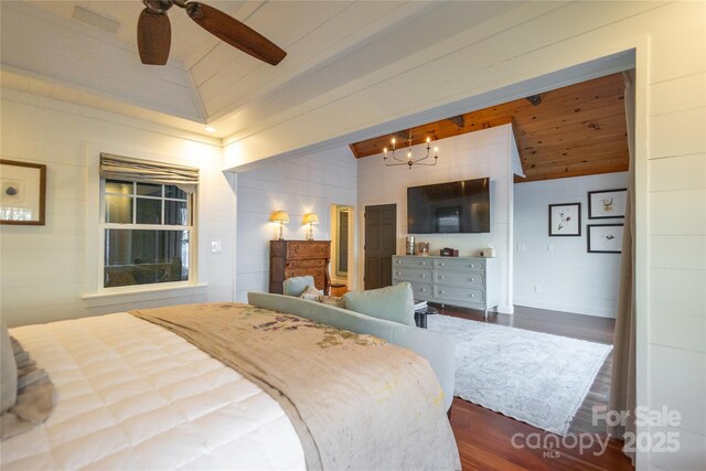 973 Sitting Rock Trl, Cullowhee, NC 28723 - bedroom featuring dark wood-type flooring, a chandelier, and a ceiling fan