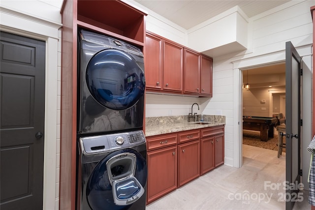 973 Sitting Rock Trl, Cullowhee, NC 28723 - washroom featuring stacked washer / drying machine, cabinet space, and wood walls