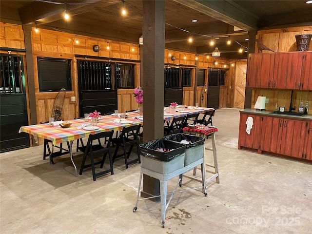 973 Sitting Rock Trl, Cullowhee, NC 28723 - dining space featuring concrete flooring and beamed ceiling