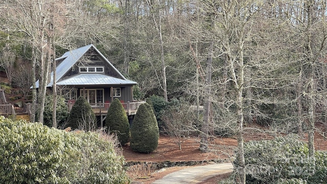 973 Sitting Rock Trl, Cullowhee, NC 28723 - view of front of property with metal roof, a wooded view, and a porch