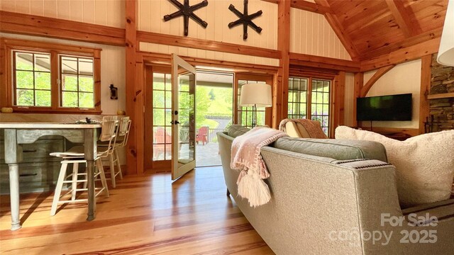 973 Sitting Rock Trl, Cullowhee, NC 28723 - living area featuring high vaulted ceiling, wood finished floors, plenty of natural light, wood walls, and a bar