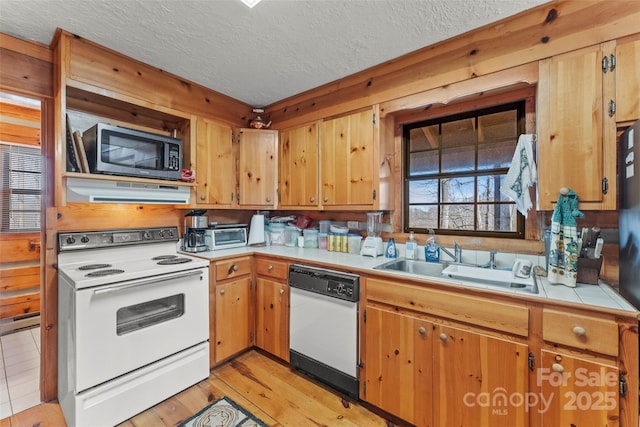 178 Tablerock Dr, Saluda, NC 28773 - kitchen featuring white appliances, a sink, a textured ceiling, tile countertops, and light wood-style flooring