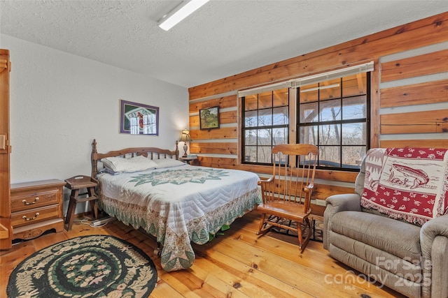 178 Tablerock Dr, Saluda, NC 28773 - bedroom with a textured ceiling, hardwood / wood-style floors, and wood walls