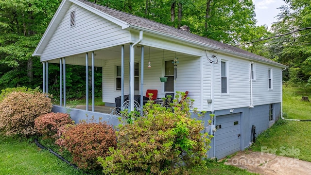 715 Broadway St NW, Lenoir, NC 28645 - view of front of home with covered porch, roof with shingles, a chimney, and a front lawn