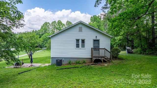 715 Broadway St NW, Lenoir, NC 28645 - back of property with cooling unit and a lawn