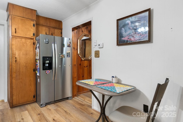 715 Broadway St NW, Lenoir, NC 28645 - kitchen with stainless steel fridge, light wood-type flooring, brown cabinets, and crown molding