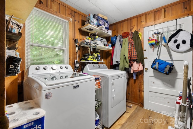 715 Broadway St NW, Lenoir, NC 28645 - laundry room featuring washing machine and clothes dryer, wood walls, and light wood-style flooring