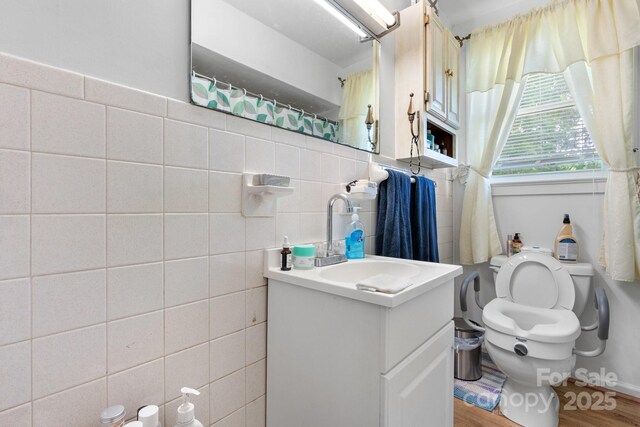 715 Broadway St NW, Lenoir, NC 28645 - full bath with tile walls, toilet, vanity, and wood finished floors
