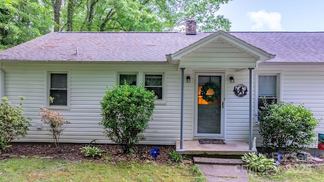 715 Broadway St NW, Lenoir, NC 28645 - view of front facade with a chimney and roof with shingles