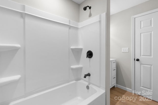 full bathroom featuring tub / shower combination, wood finished floors, and vanity