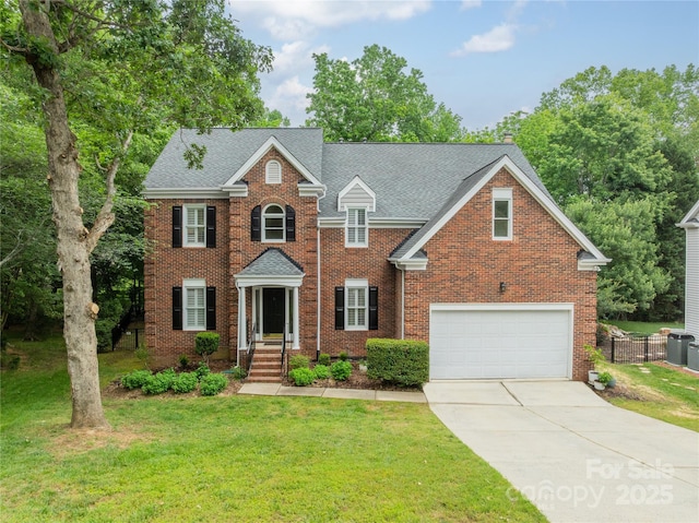 2907 Notchview Ct, Charlotte, NC 28210 - colonial home featuring an attached garage, driveway, brick siding, and a shingled roof