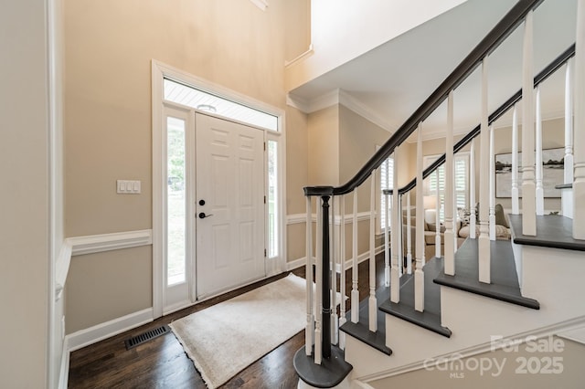 2907 Notchview Ct, Charlotte, NC 28210 - foyer entrance with stairway, wood finished floors, crown molding, and baseboards