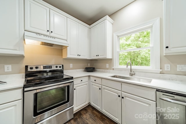 2907 Notchview Ct, Charlotte, NC 28210 - kitchen featuring stainless steel appliances, under cabinet range hood, a sink, dark wood-type flooring, and white cabinets