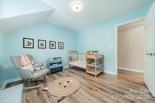 2907 Notchview Ct, Charlotte, NC 28210 - bedroom with wood finished floors, lofted ceiling, baseboards, and a nursery area