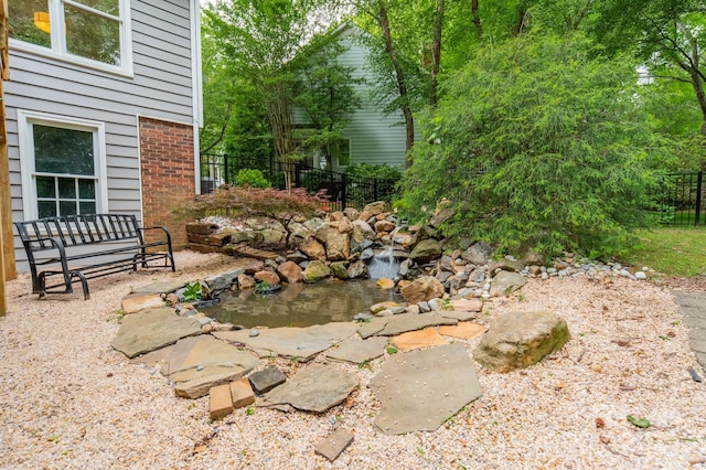 2907 Notchview Ct, Charlotte, NC 28210 - view of yard with fence and a small pond