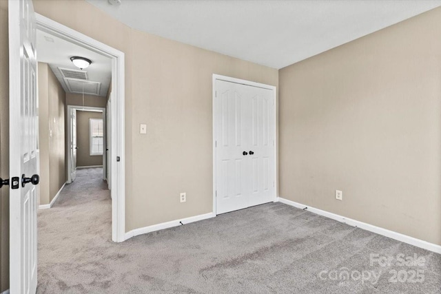 8610 Sawleaf Ct, Charlotte, NC 28215 - unfurnished bedroom featuring attic access, carpet, baseboards, and a closet