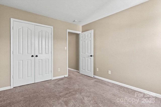 8610 Sawleaf Ct, Charlotte, NC 28215 - unfurnished bedroom with carpet floors, a closet, and baseboards